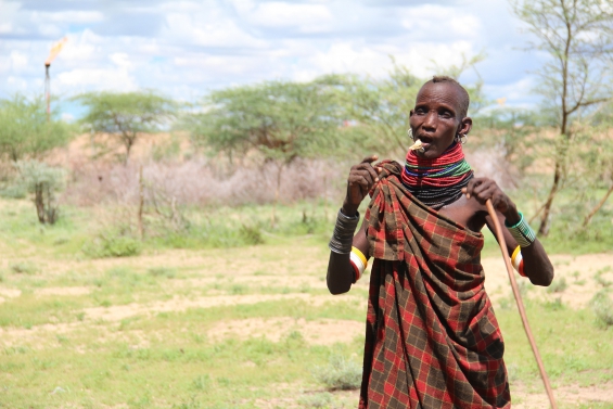 Turkana herder by gas flare